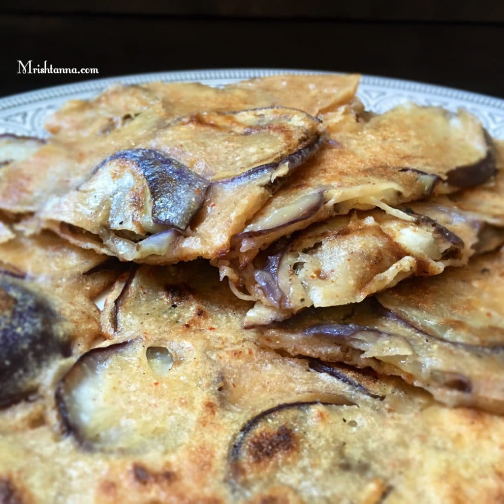 A piece of food, with Eggplant and Dosa