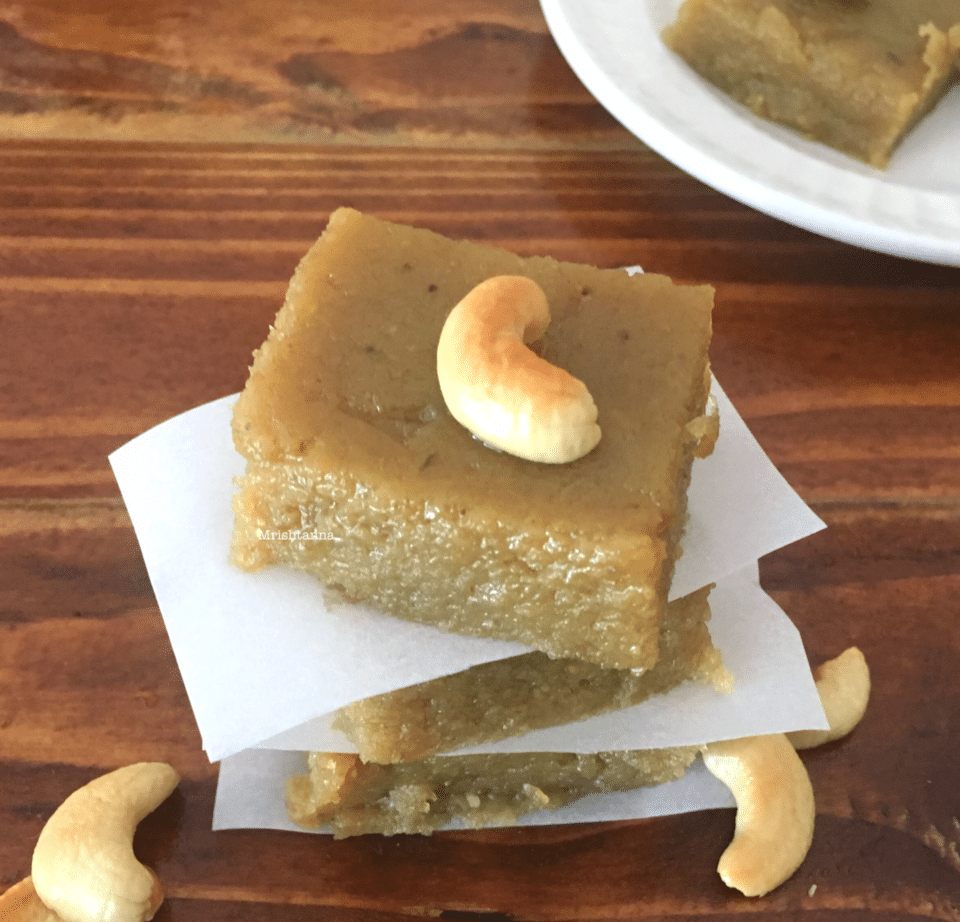 A piece of halwa on a wooden cutting board