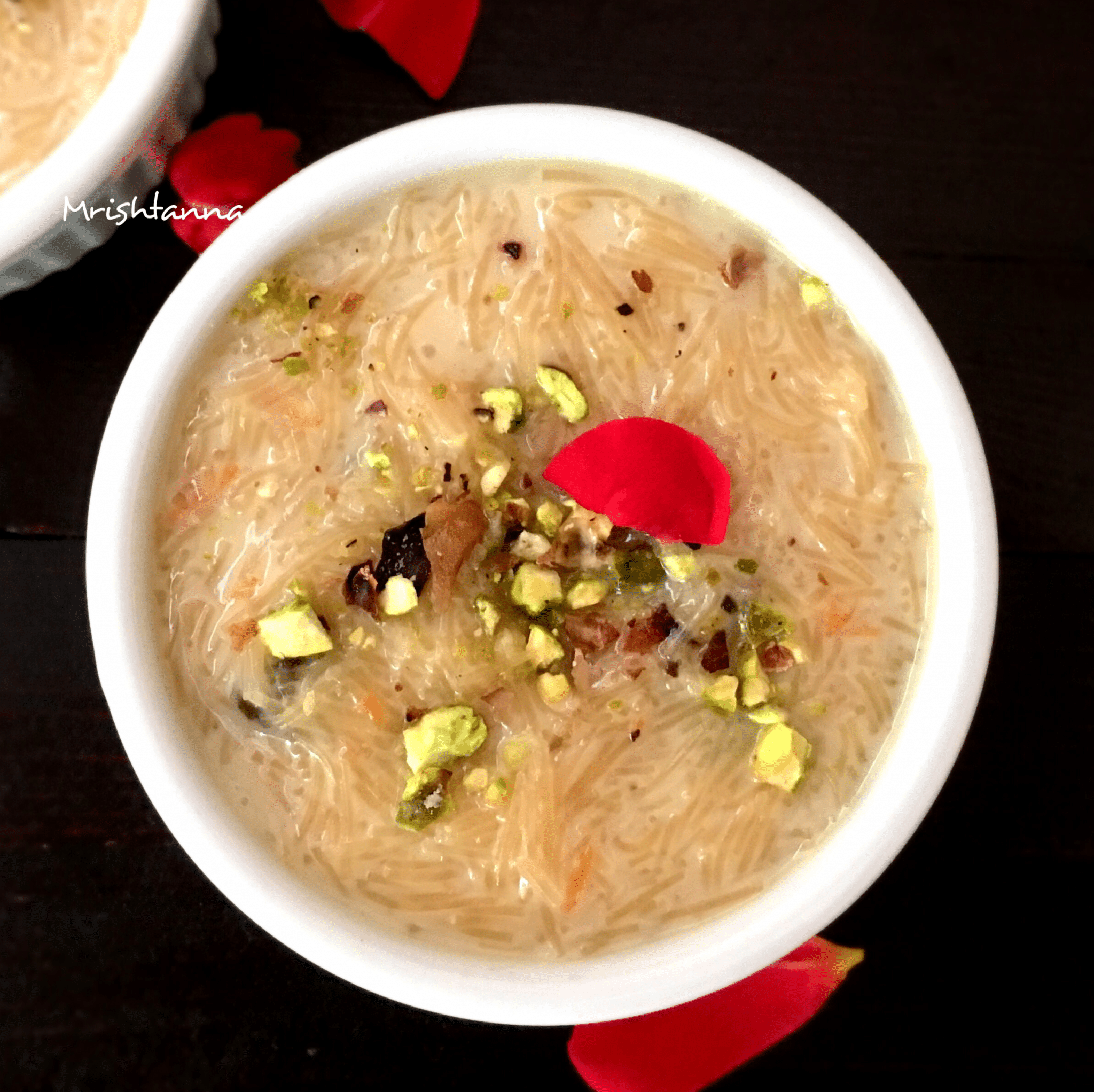 A bowl of food on a plate, with Kheer and Vermicelli