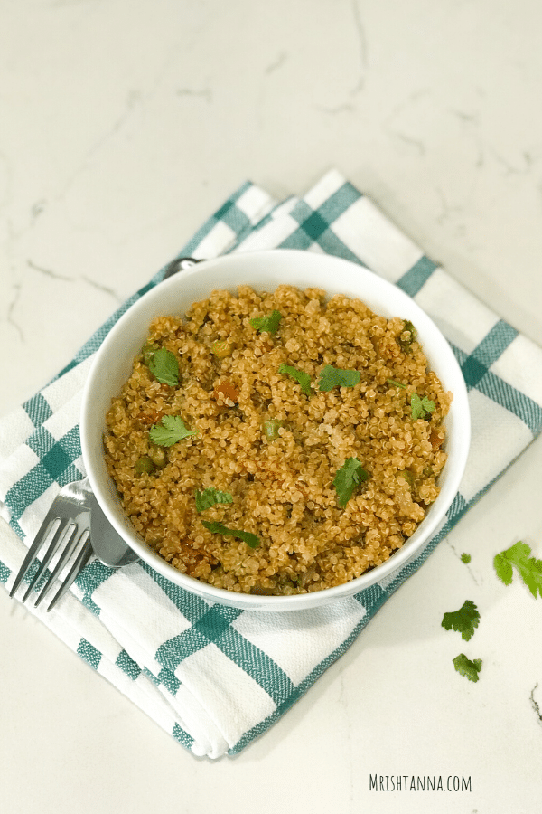 A bowl of food, with Quinoa and Rice