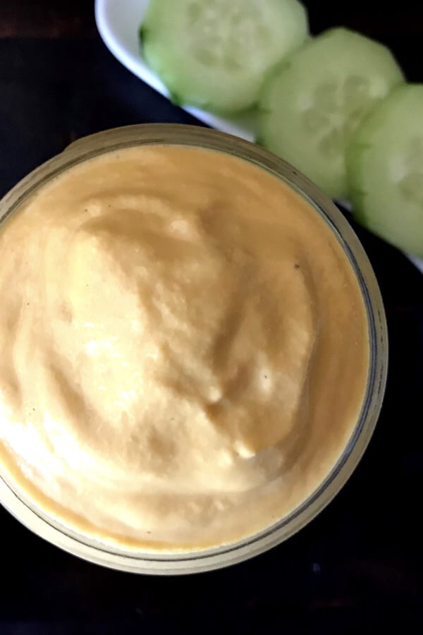 A bowl of food on a plate, with Carrot and Ranch dressing