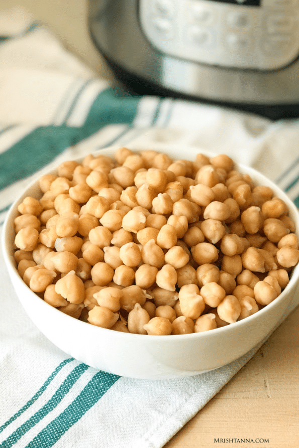 A bowl of food on a table, with Chickpea and Bean