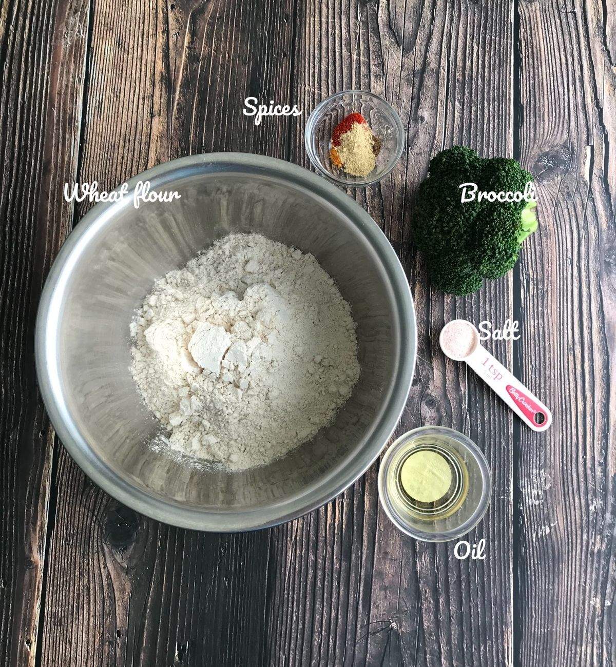 Different bowls are filled with broccoli paratha ngredients