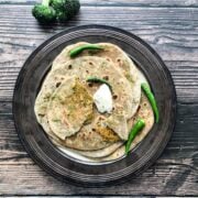 broccoli paratha's are on the big brown plate and topped with vegan butter