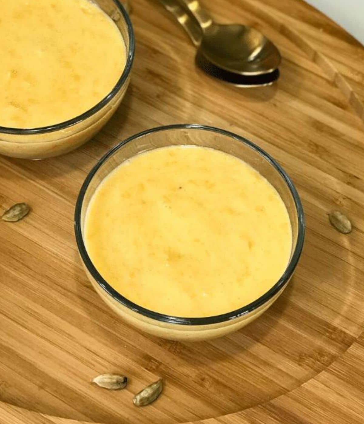 A glass bowl is filled with aamras.