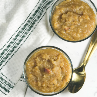 A bowl of food on a plate, with Dal