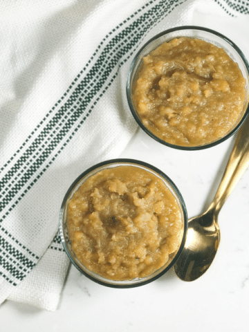 A bowl of food on a plate, with Dal