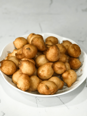 A plate with urad dal bonda on the table