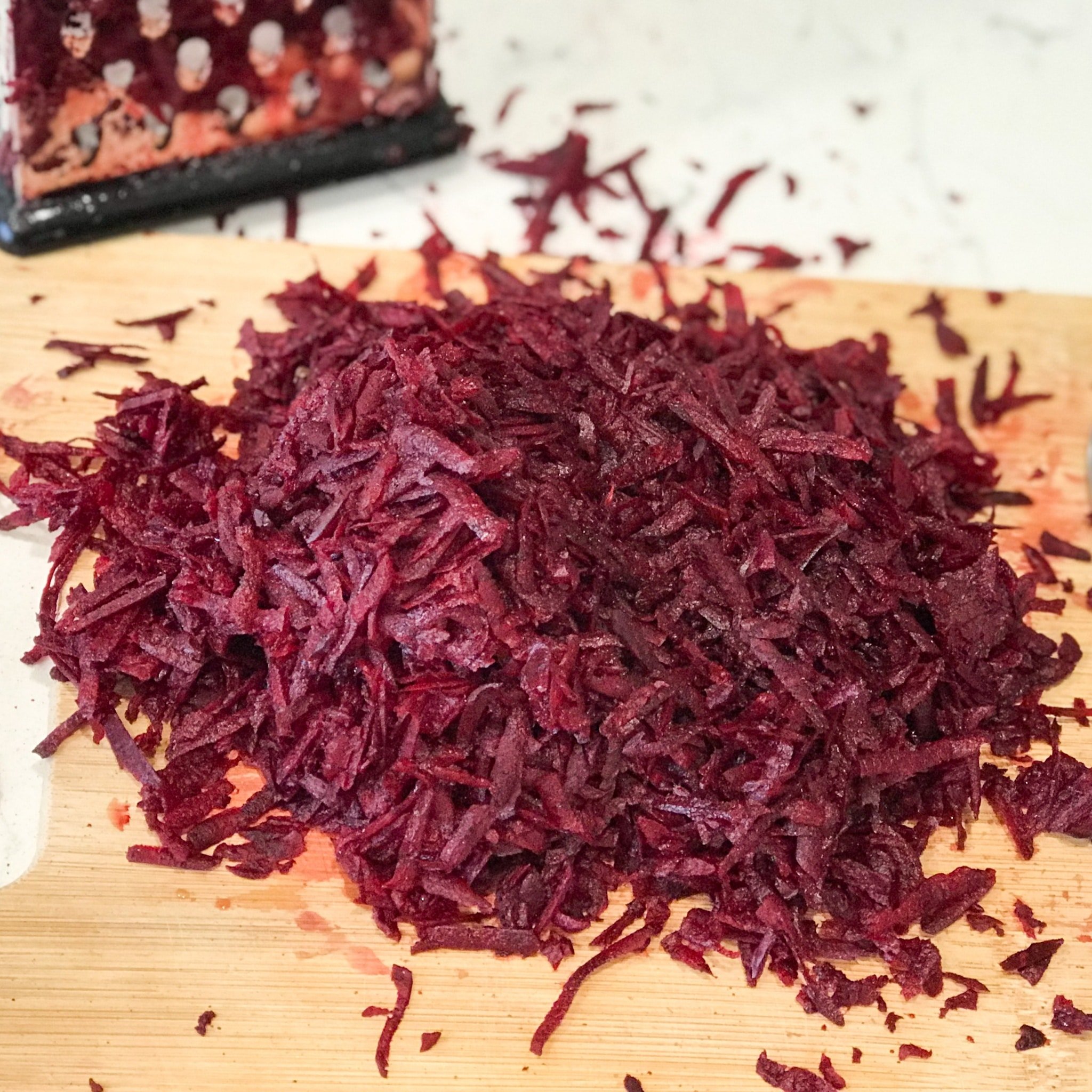 Grated beets is on the cutting board