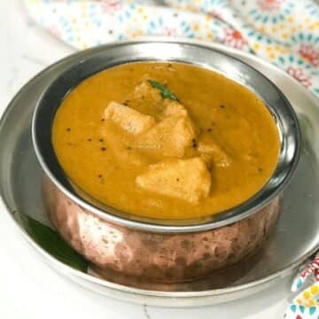 A copper bowl is with pineapple gojju on the plate.