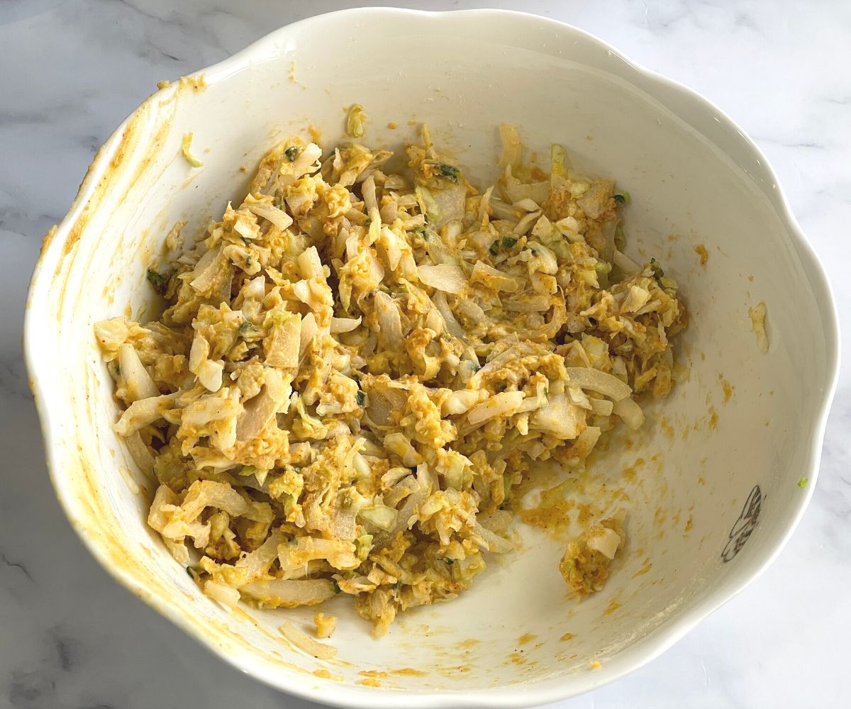 A bowl is with air fryer pakora batter.