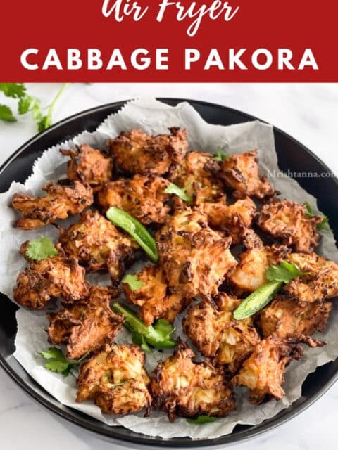 Air fried pakoras and fried chilies are on the plate topped with cilantro.