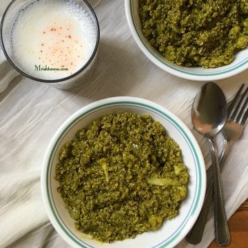 A bowl of spinach quinoa and with glass of butter milk