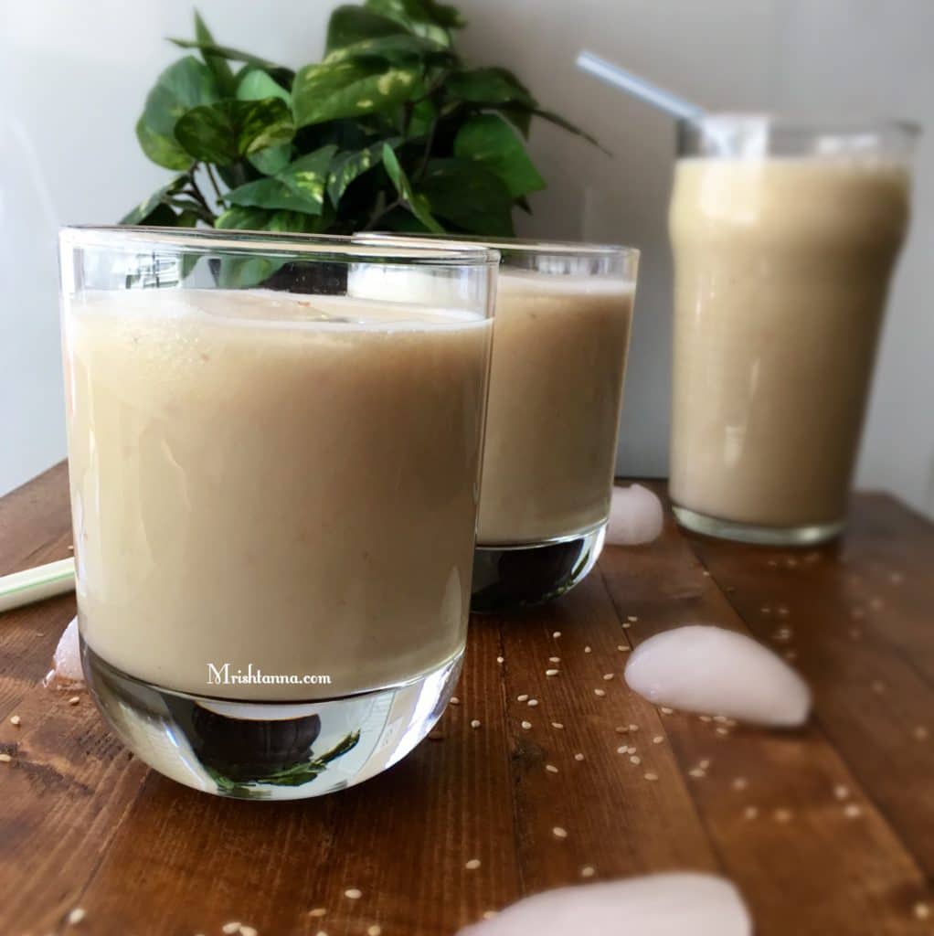  a glass of sesame juice on a table.