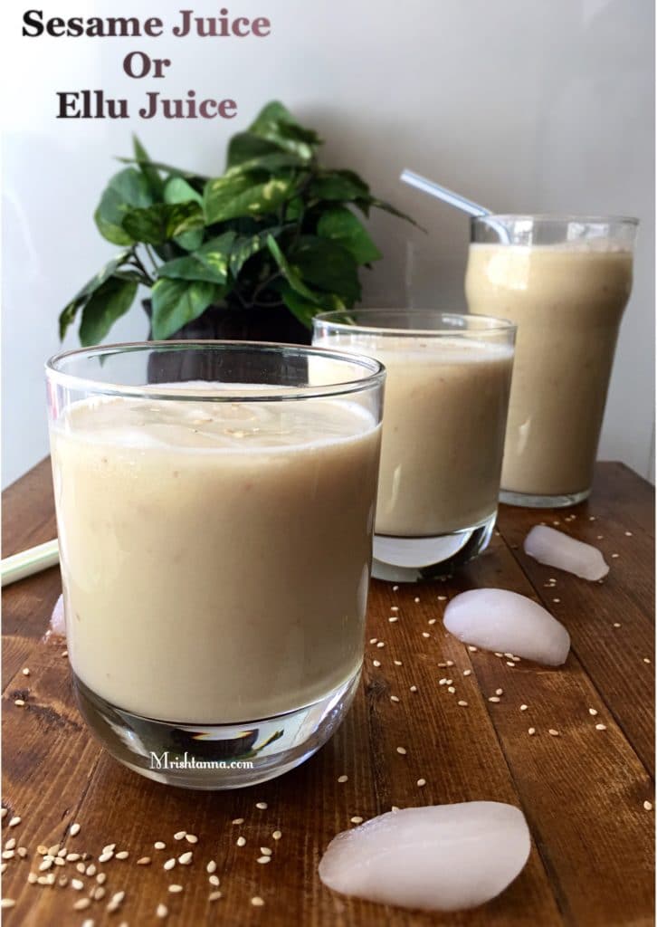 A cup of sesame juice on the table with straws on.