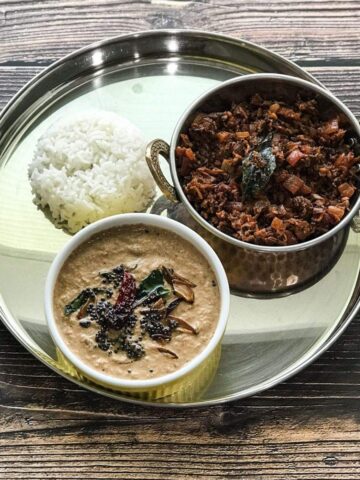 A plate is with banana blossom chutney and stir fry on the table