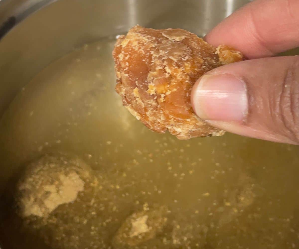 kashayam making, holding a piece of jaggery.