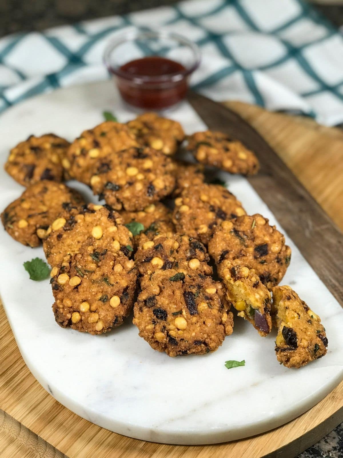 Masala vada is placed on the white serving tray