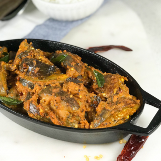 A plate of masala curry is on the table.