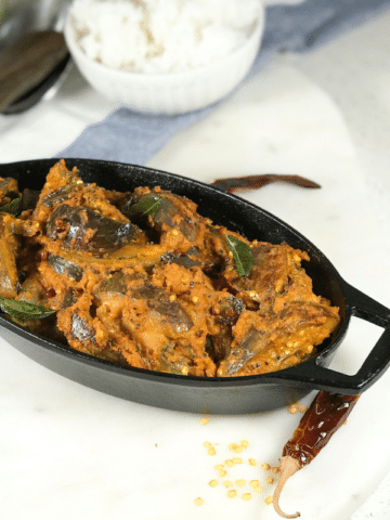A plate of masala curry is on the table.