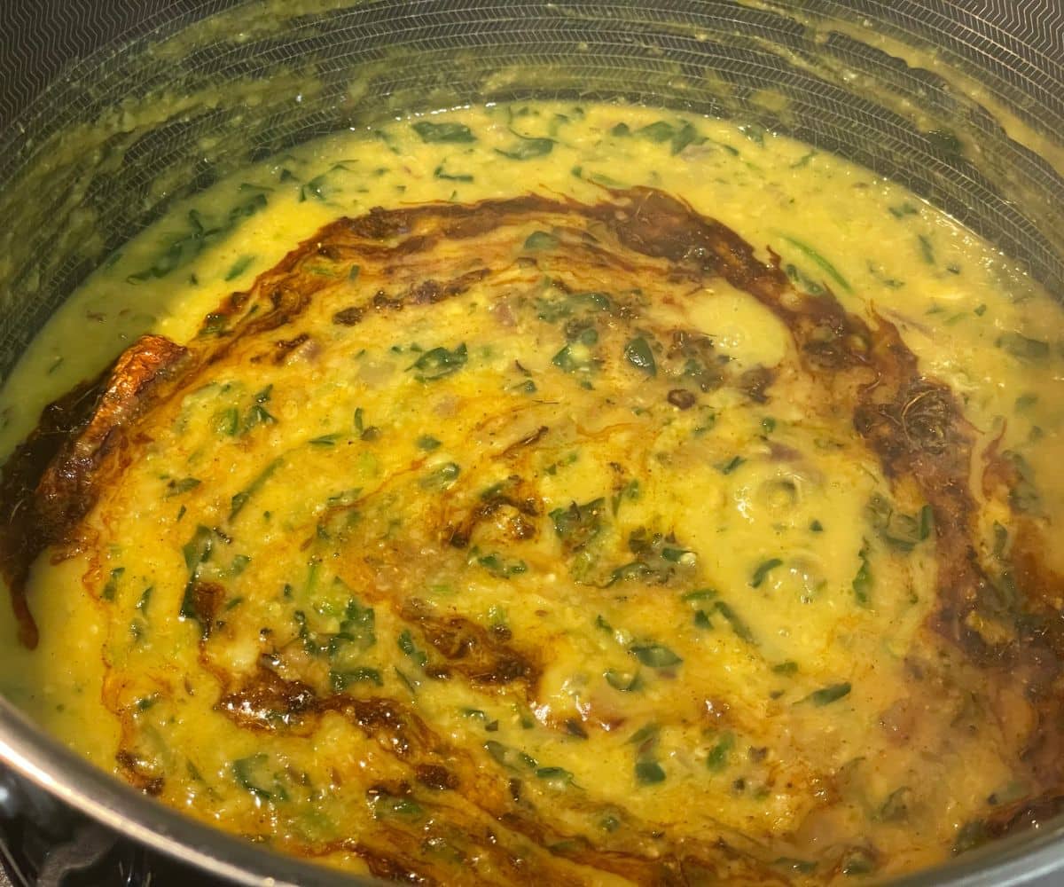 A pan is with palak dal.