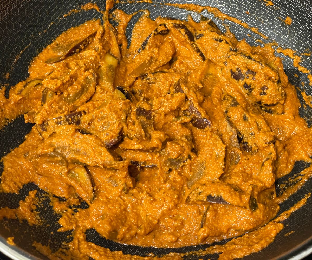 A pan is with brinjal curry over the heat.