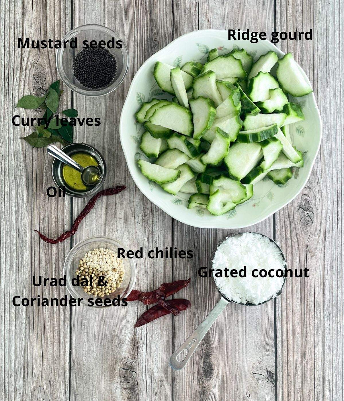 A table is with all the ingredients for chutney like ridge gourd, coconuts, spices.