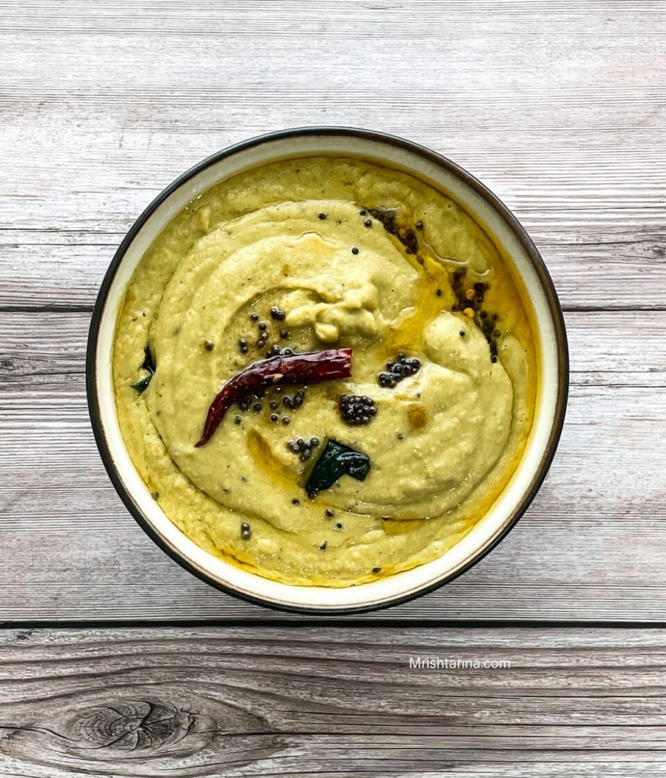 A bowl of ridge gourd chutney is on the table