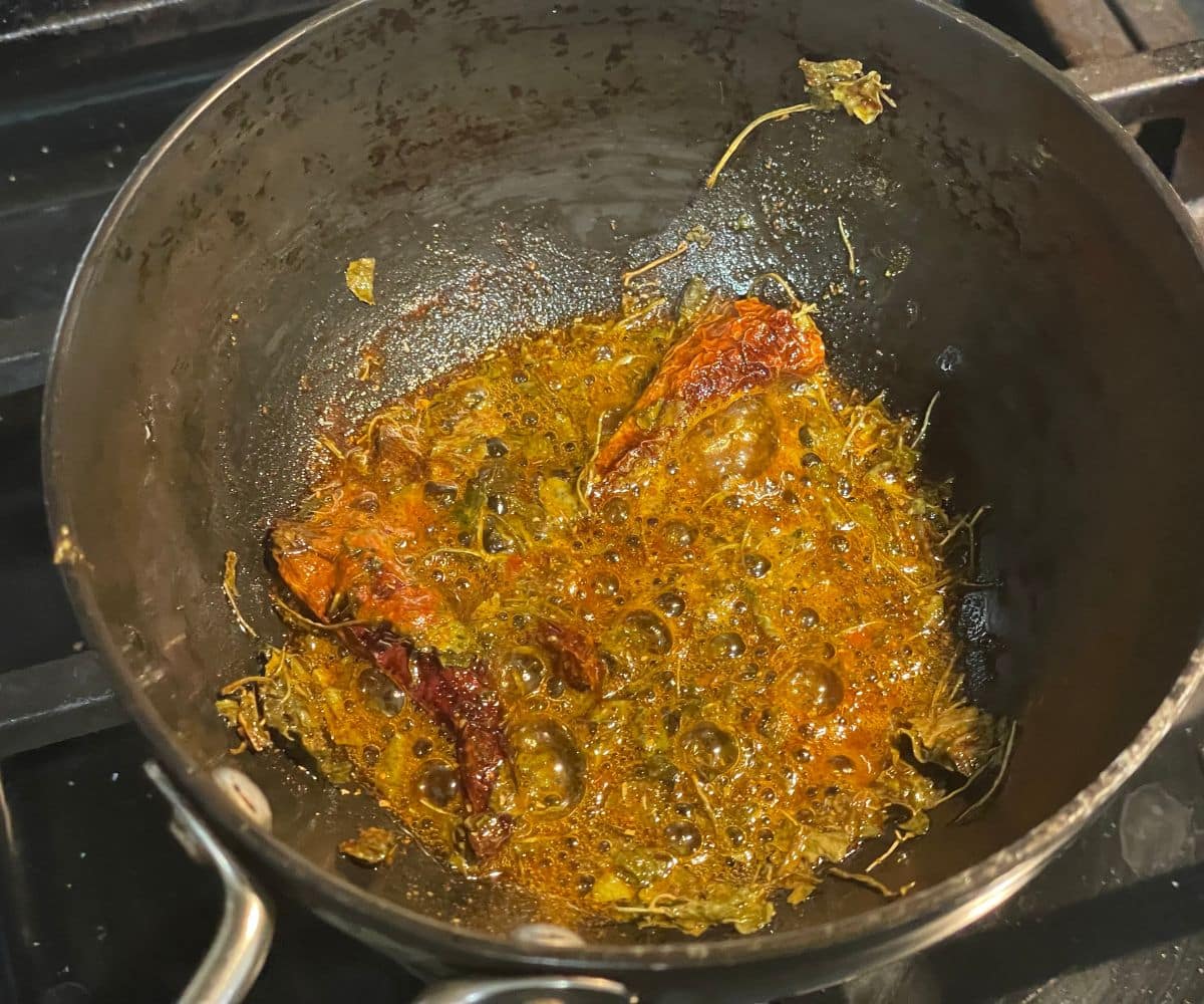 A heated pan is with tadka.