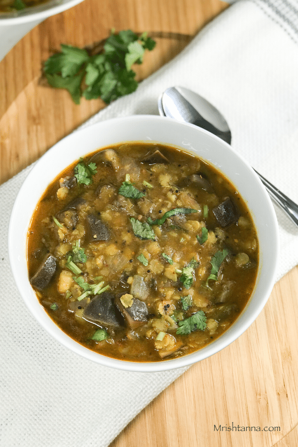 A bowl with Brinjal Sambar is on the table