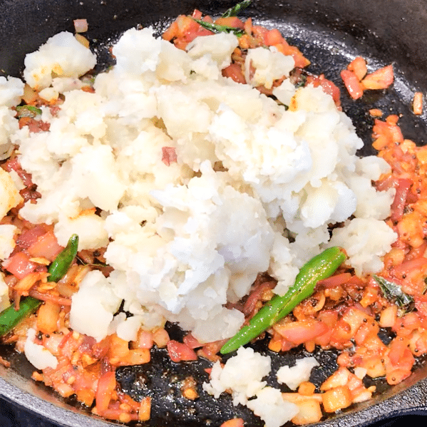 A pan filled with mashed potatoes and chilies.