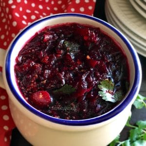 A bowl of food on a table, with Beetroot and Curry
