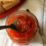 A bowl of food sitting on a table, with Tomato and Jam