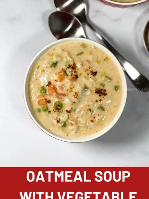 A bowl of oatmeal soup with vegetables is on the surface.