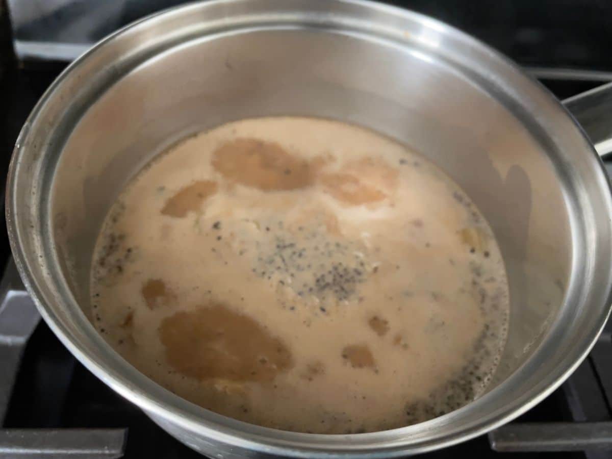 A pan is with boiling vegan chai over the heat.