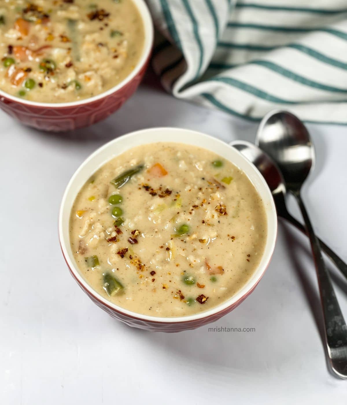 Two bowls of oatmeal soup are on the table.