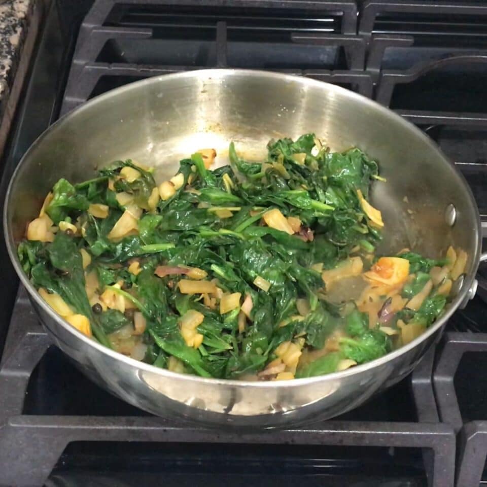 pan is with spinach leaves and spices for spinach soup