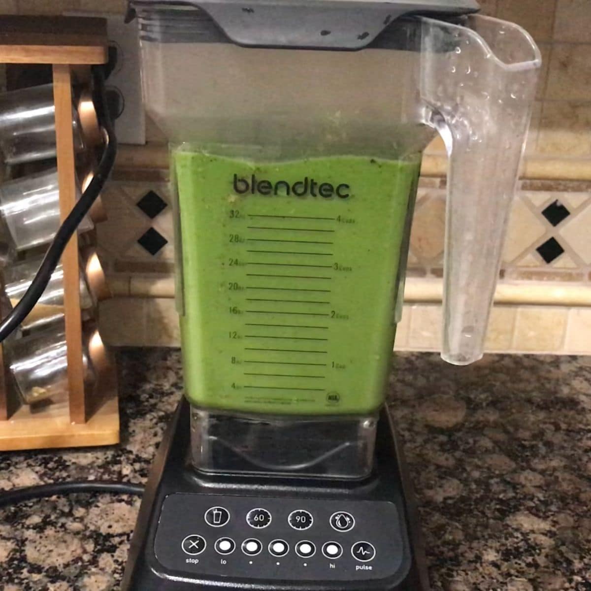 A blender filled with spinach and boiled potatoes