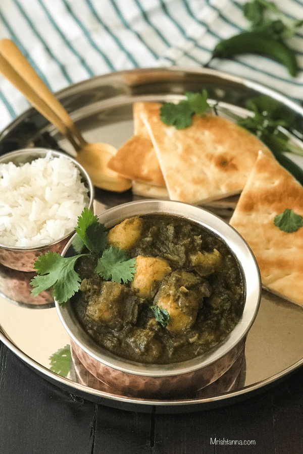 A bowl of food on a plate, with Spinach and Potato