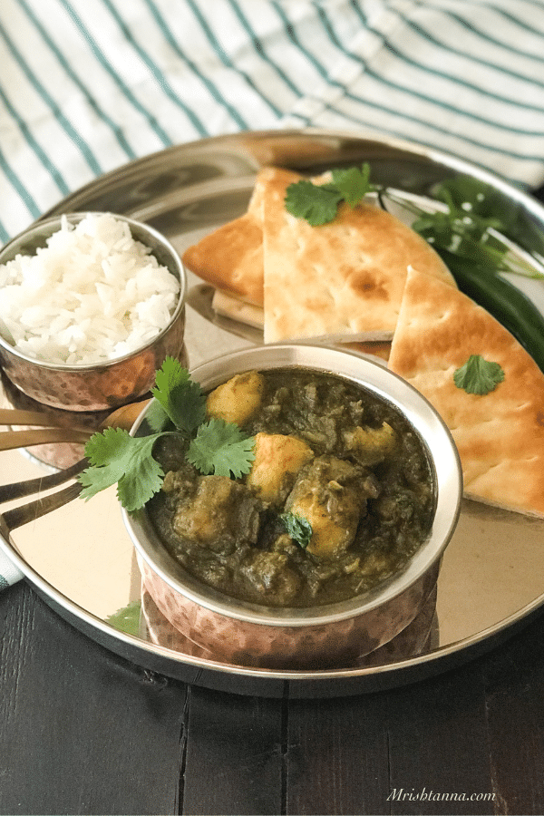 A bowl of food on a plate, with Curry