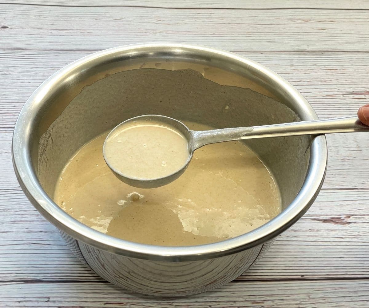 Bow of wheat dosa batter is on the table.