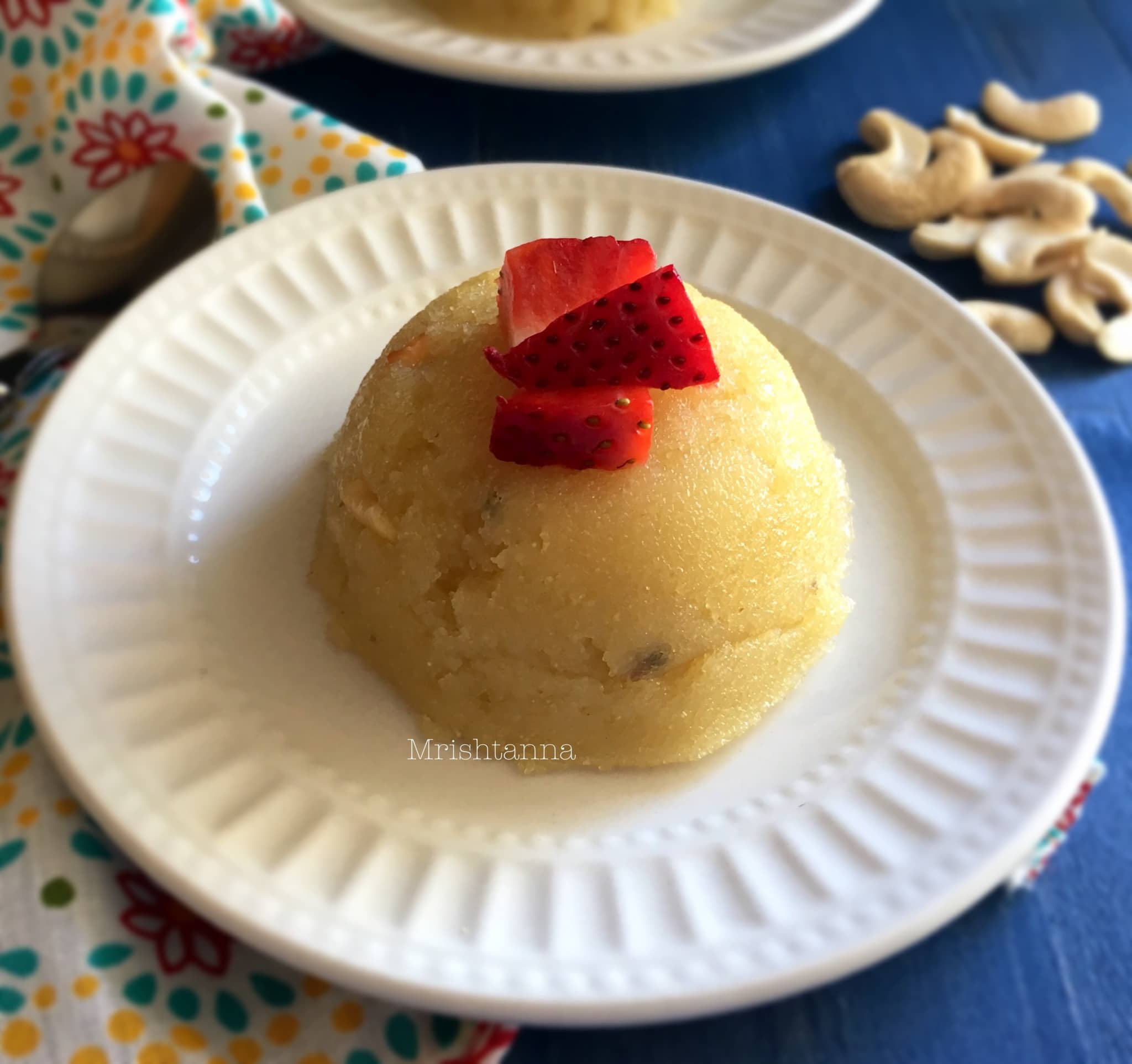 Rava Kesari on a plate, with strawberry on top