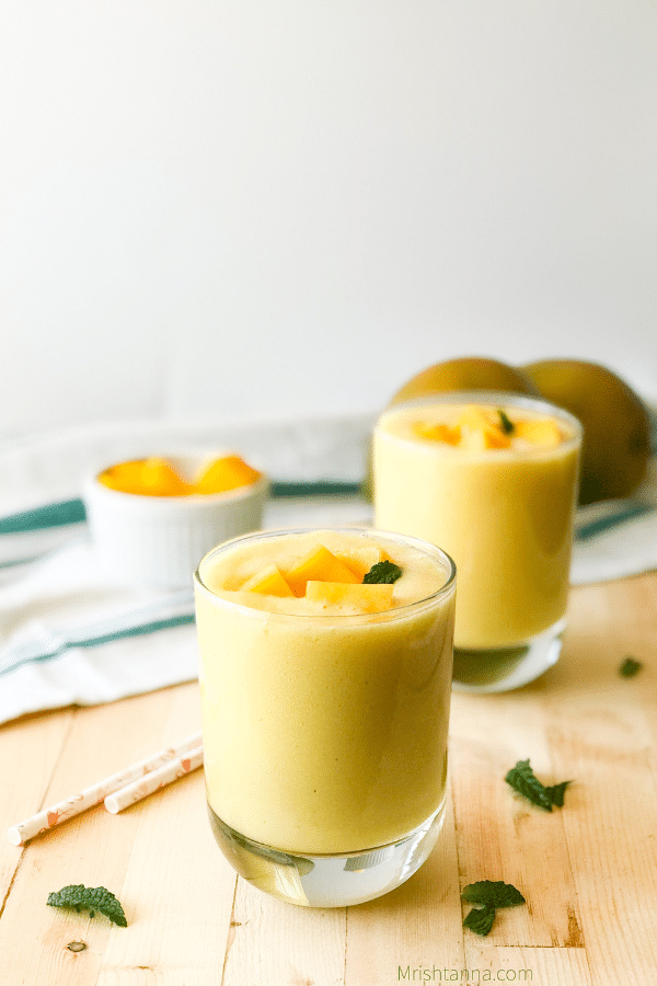 A close up of mango lassi on a jar and placed on the table