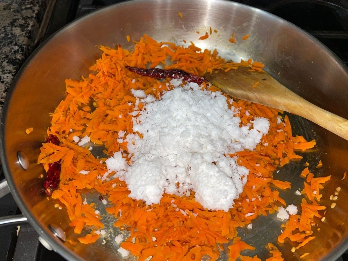 A pan is with grated carrots and coconuts