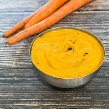 A bowl of carrot chutney is on the table
