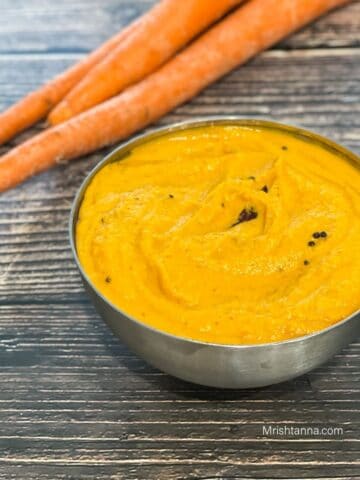 A bowl of carrot chutney is on the table