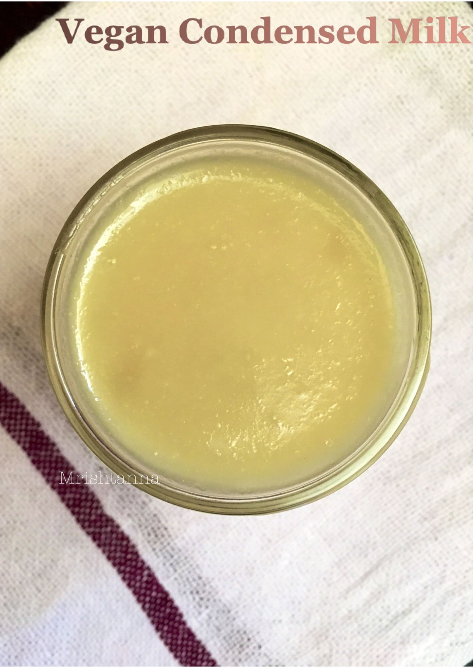 Vegan Condensed Milk Recipe A jar is filled Vegan Condensed Milk and placed on the table