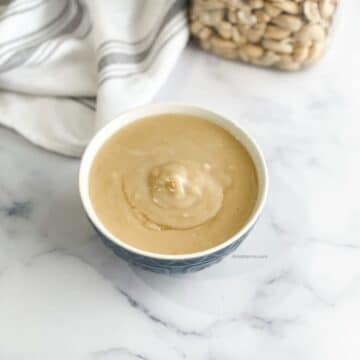 A bowl of vegan condensed milk is on the table.