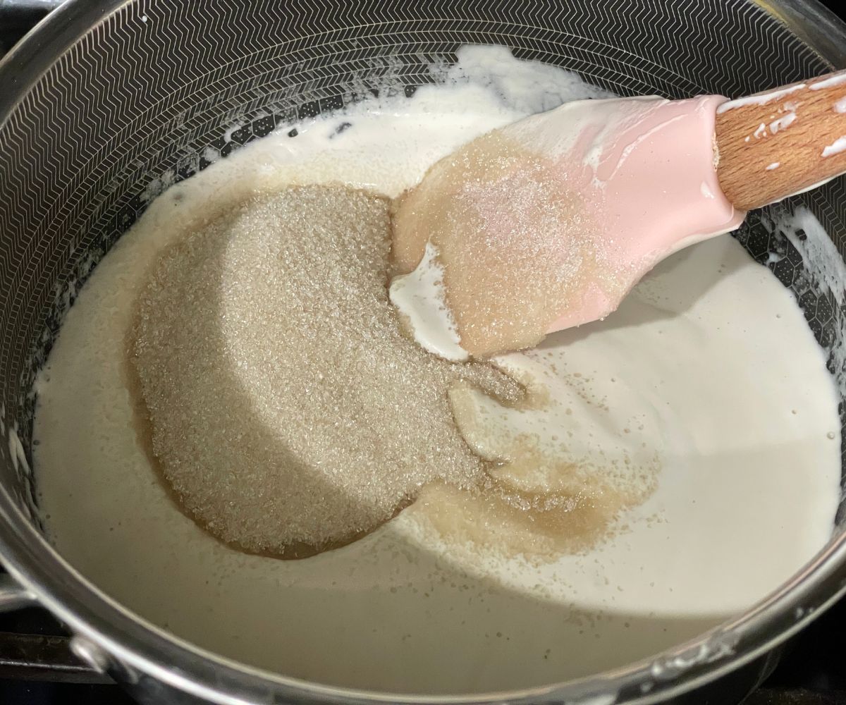 A pan is full of blended cashews and sugar.