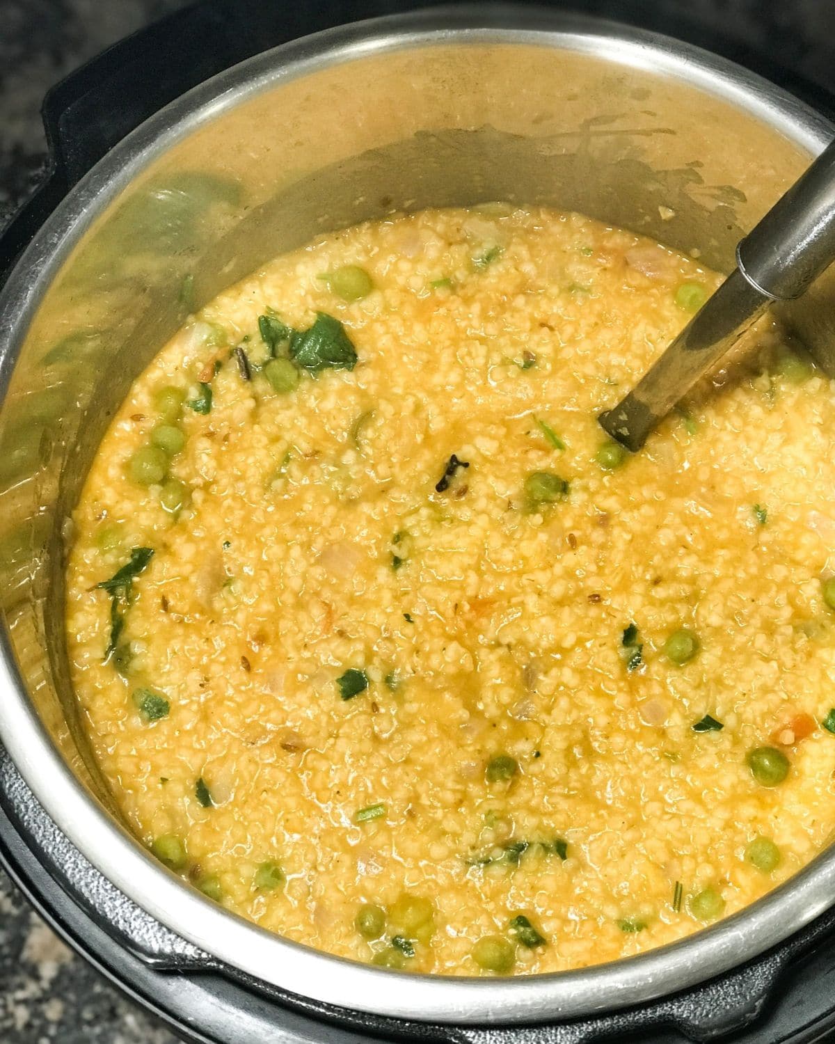 An instant pot is filled with dalia khichdi